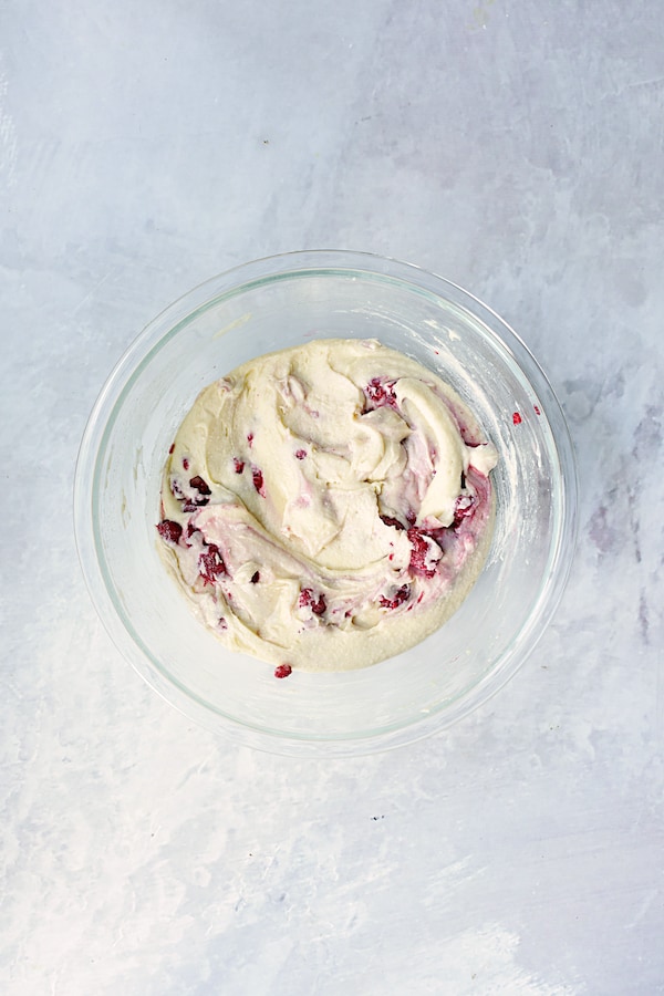 Photo of all ingredients for cake combined in glass mixing bowl.