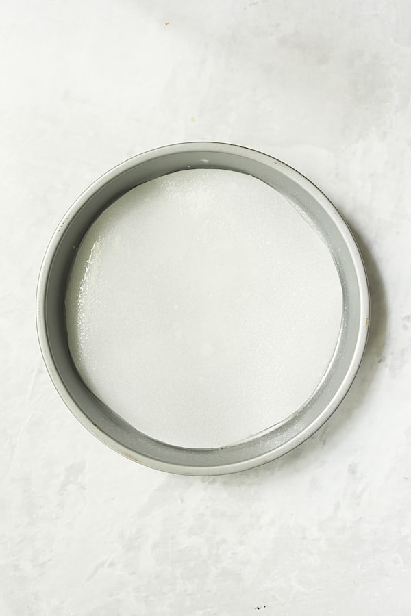 Photo of round parchment lined baking pan.