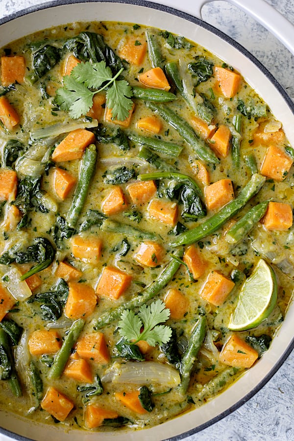 Close-up photo of Vegan Thai Green Sweet Potato Curry in white pan.