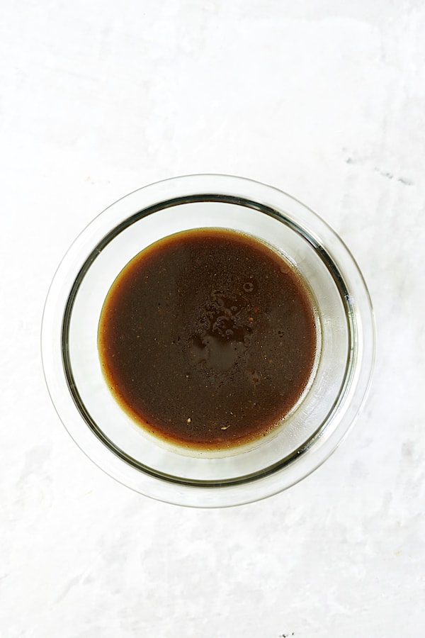 Photo of honey balsamic dressing in white bowl.