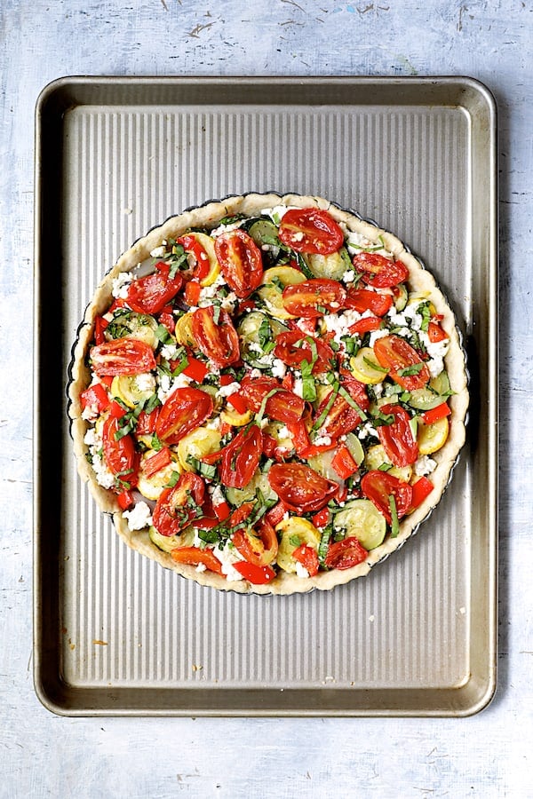 Photo of vegetable-filled tart pan before being baked.