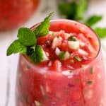 Watermelon Gazpacho with Serrano Chiles and Mint - Close-up shot of gazpacho in glass garnished with fresh mint