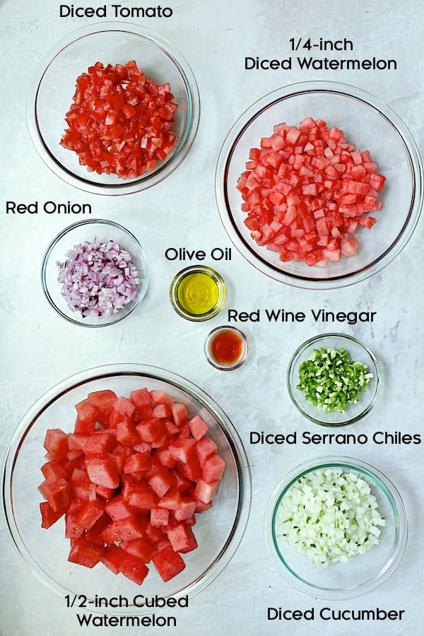 Photo of ingredients for watermelon gazpacho in glass bowls.
