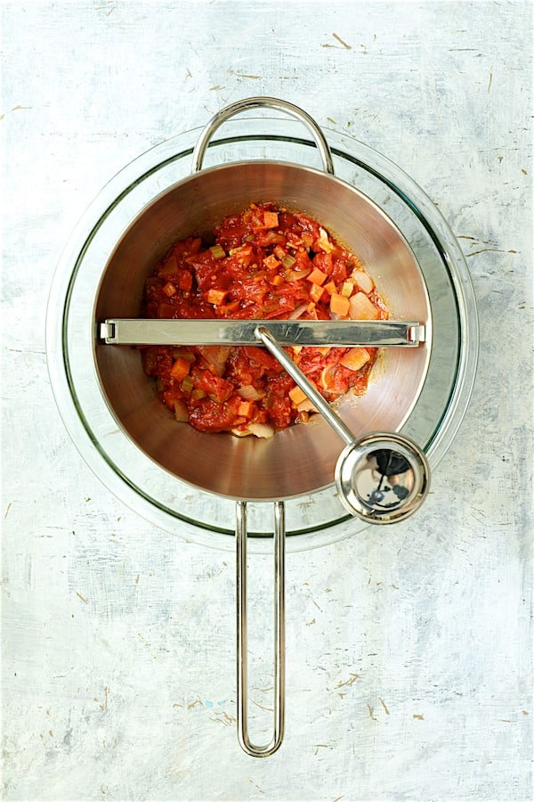 Photo of sauce ingredients being processed in food mill.