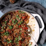 Moroccan-Spiced Caponata - Overhead hero shot of caponata being served up on crusty bread