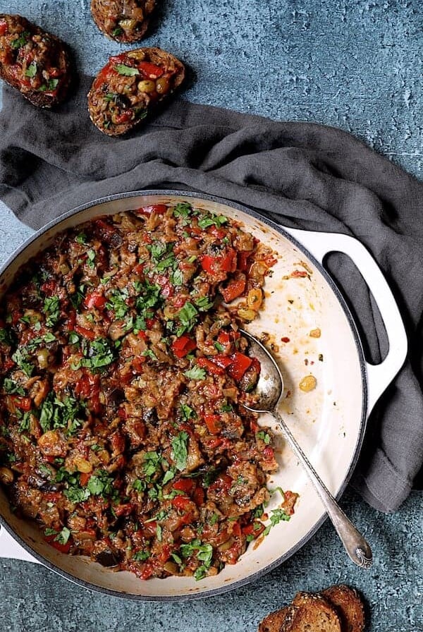Moroccan-Spiced Caponata - Overhead hero shot of caponata being served up on crusty bread