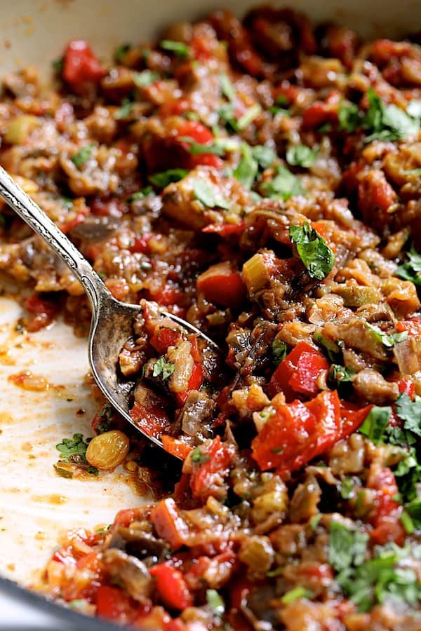 Close-up photo of finished Moroccan-Spiced Caponata with serving spoon.