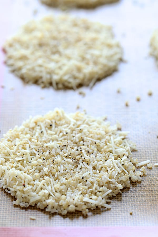 Photo of unbaked Quinoa Parmesan Crisps on Silpat-lined baking sheet.