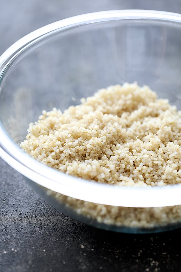 Photo of cooked quinoa in glass mixing bowl.