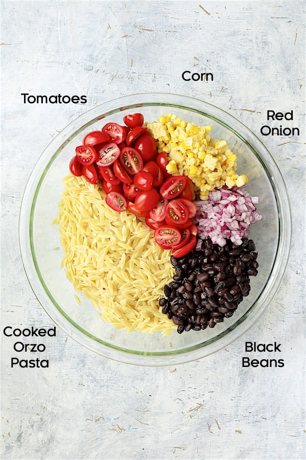 Photo of ingredients for Southwestern Orzo Salad with Cilantro Lime Dressing in glass bowl.