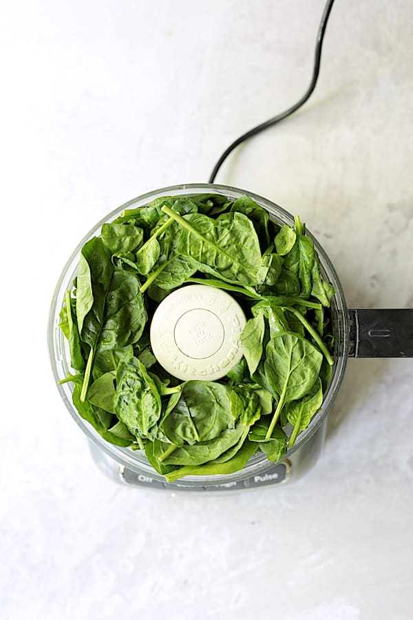 Photo of spinach leaves in food processor.