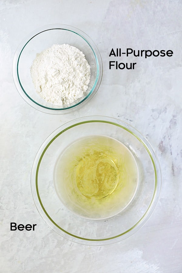 Photo of ingredients for beer batter in glass bowls.