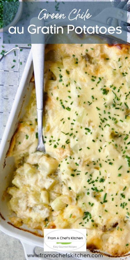 Pinterest graphic for Green Chile au Gratin Potatoes showing it in a white rectangular baking dish with serving spoon scooping some up.