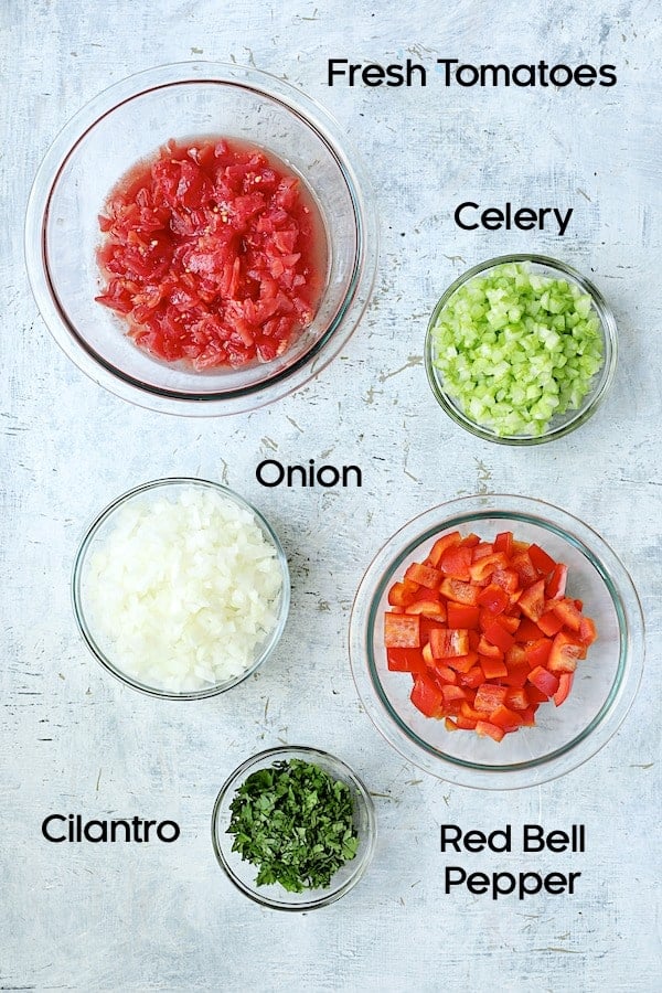 Photo of fresh ingredients for caponata in glass bowls.