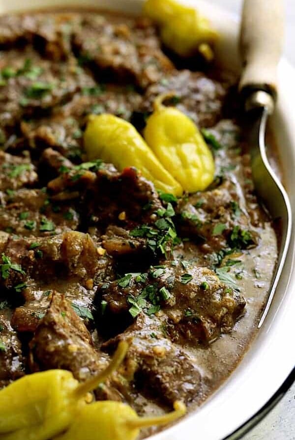 Mississippi-Style Boneless Short Ribs - Close-up shot on white platter with meat fork
