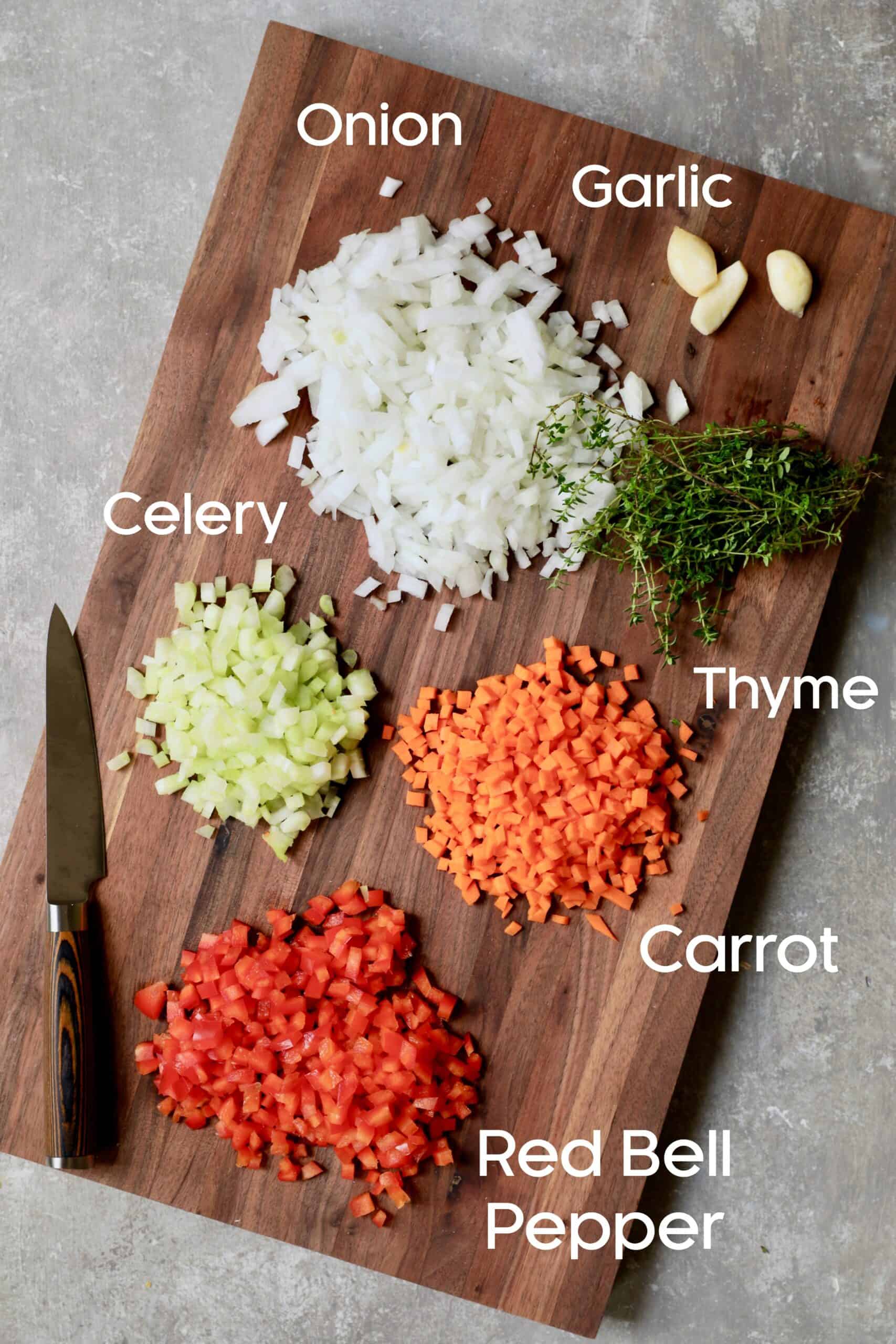 Photo of cut vegetables on wood cutting board.