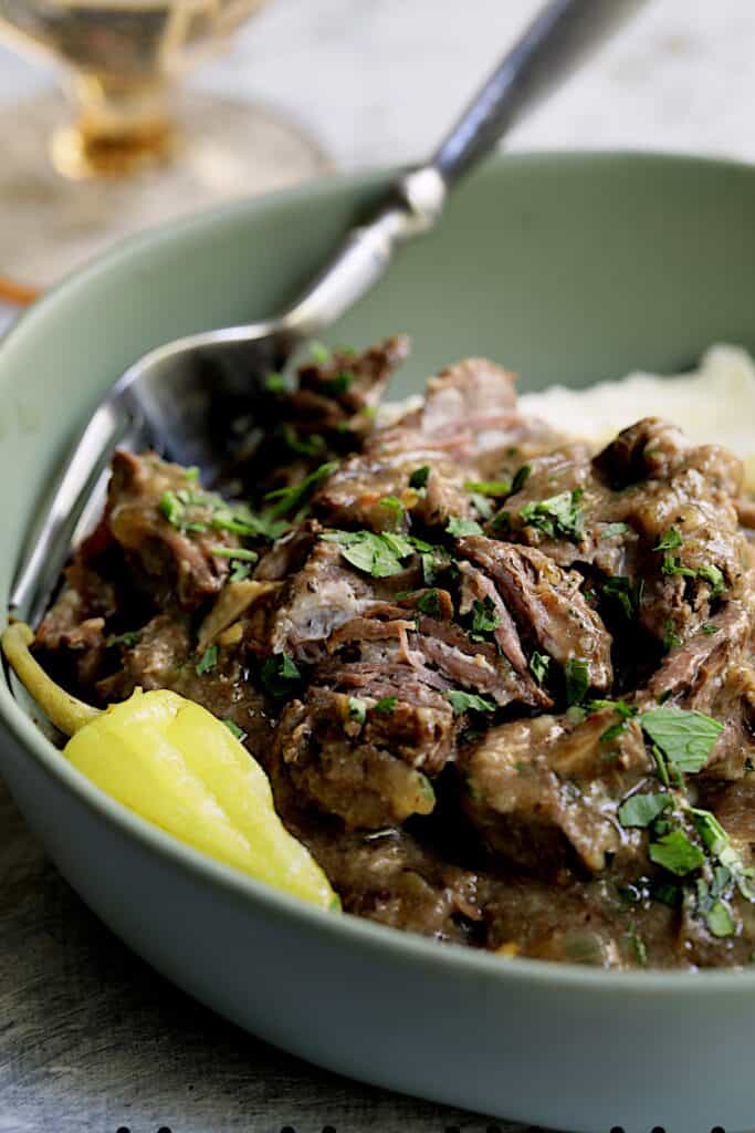 Close-up photo of Mississippi-Style Boneless Beef Short Ribs in green bowl.