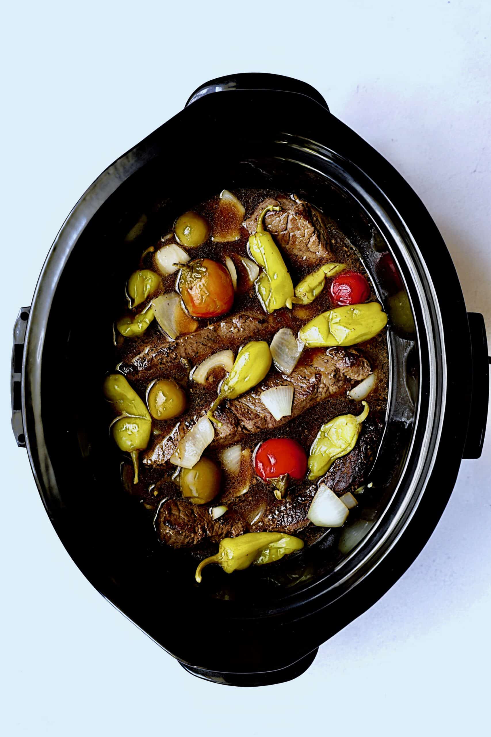 Photo of short ribs in slow cooker before cooking.