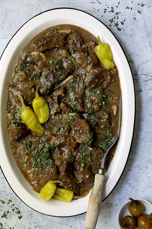 Photo of Mississippi-Style Boneless Short Ribs on white platter with meat fork.