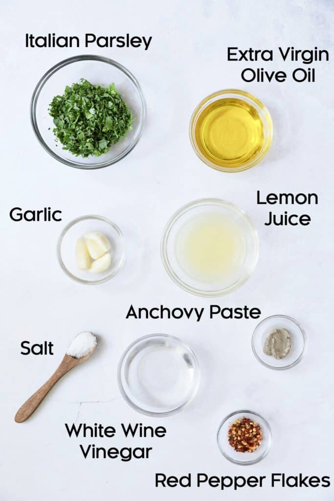 Photo of ingredients for Carrot Top Salsa Verde in glass bowls.