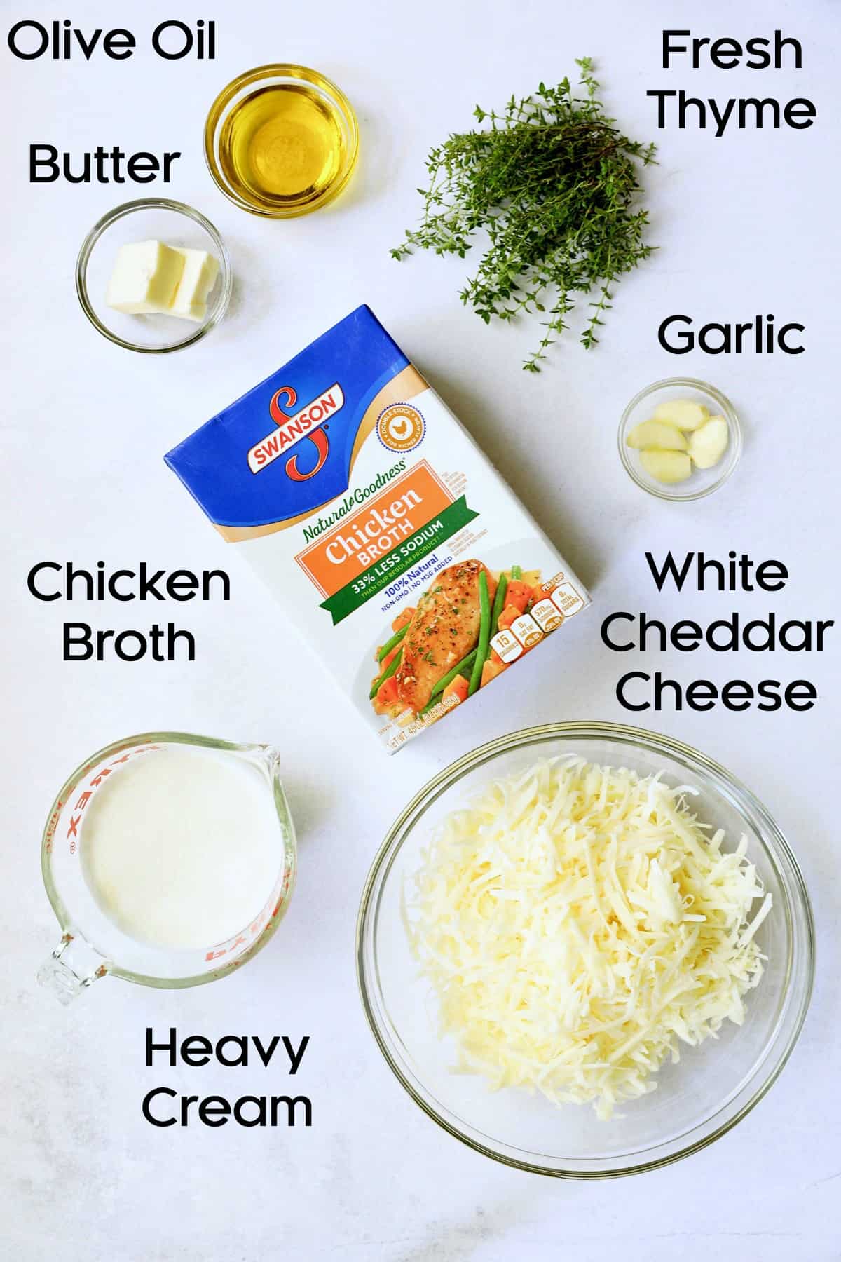 Photo of ingredients for Potato Leek Soup with White Cheddar in glass bowls.
