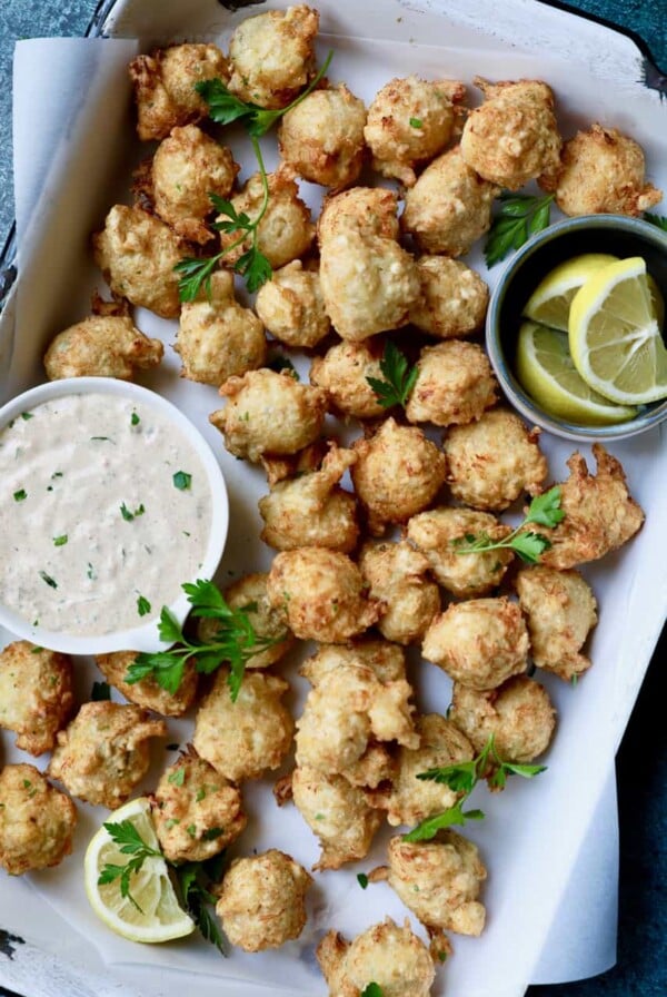 Crab and Artichoke Beignets with Jalapeno Remoulade - Overhead shot of beignets in white pan