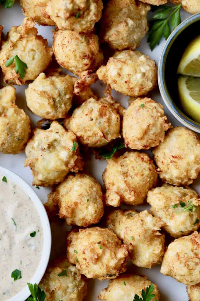 Close-up photo of Crab and Artichoke Beignets with Jalapeno Remoulade.