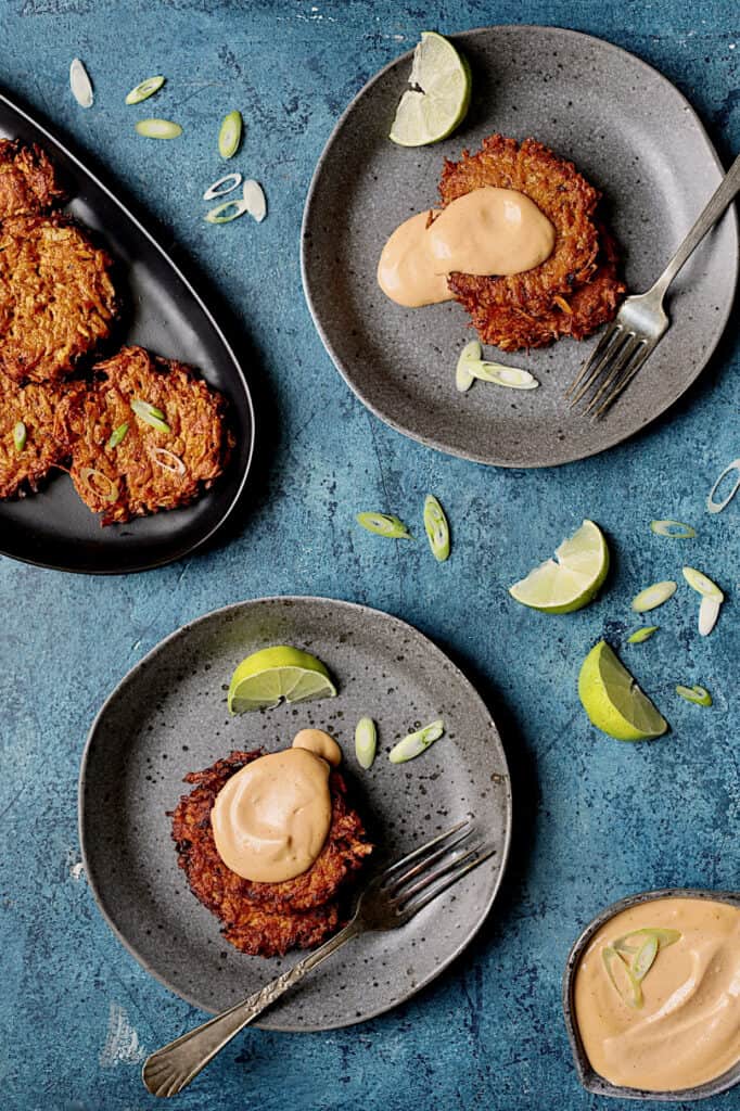 Photo of Korean Sweet Potato Latkes with Gochujang Mayonnaise on gray plates.