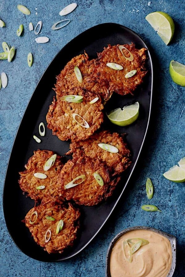 Korean Sweet Potato Fritters with Gochujang Mayonnaise - Overhead shot of fritters on angled black platter