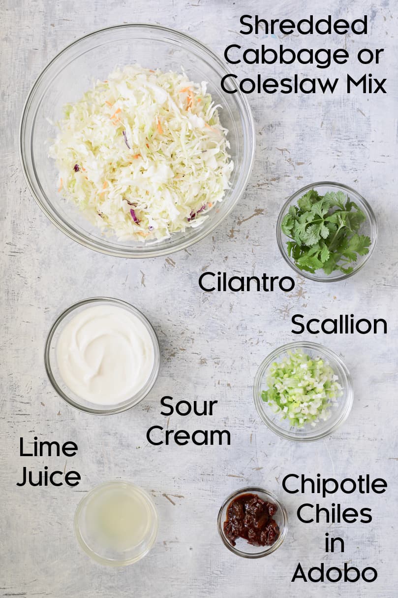 Photo of ingredients for slaw in glass bowls.