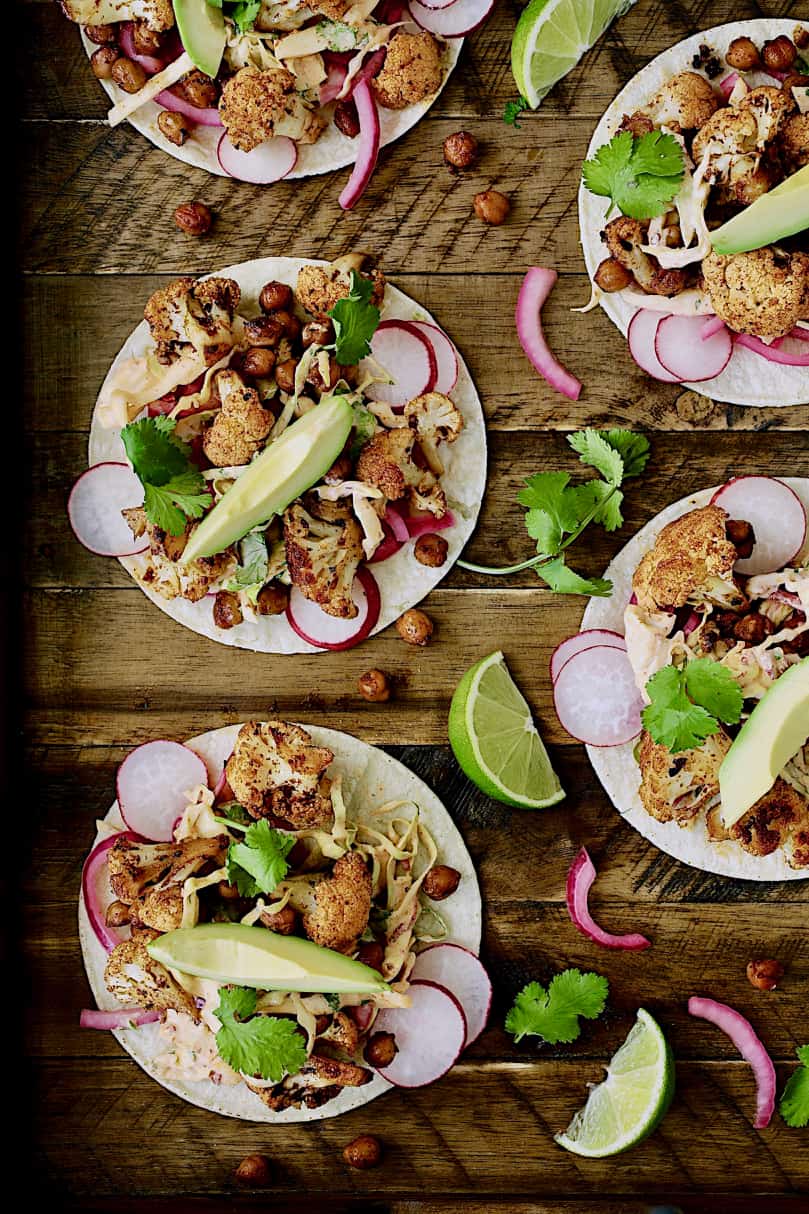 Photo of Cauliflower and Chickpea Tacos with Chipotle Lime Slaw on wood board.