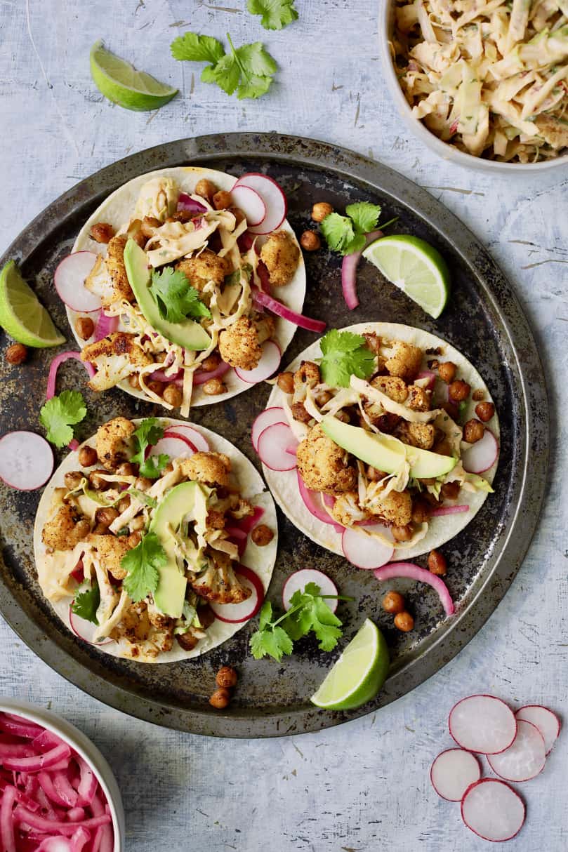 Photo of three Cauliflower and Chickpea Tacos with Chipotle Lime Slaw on round platter.