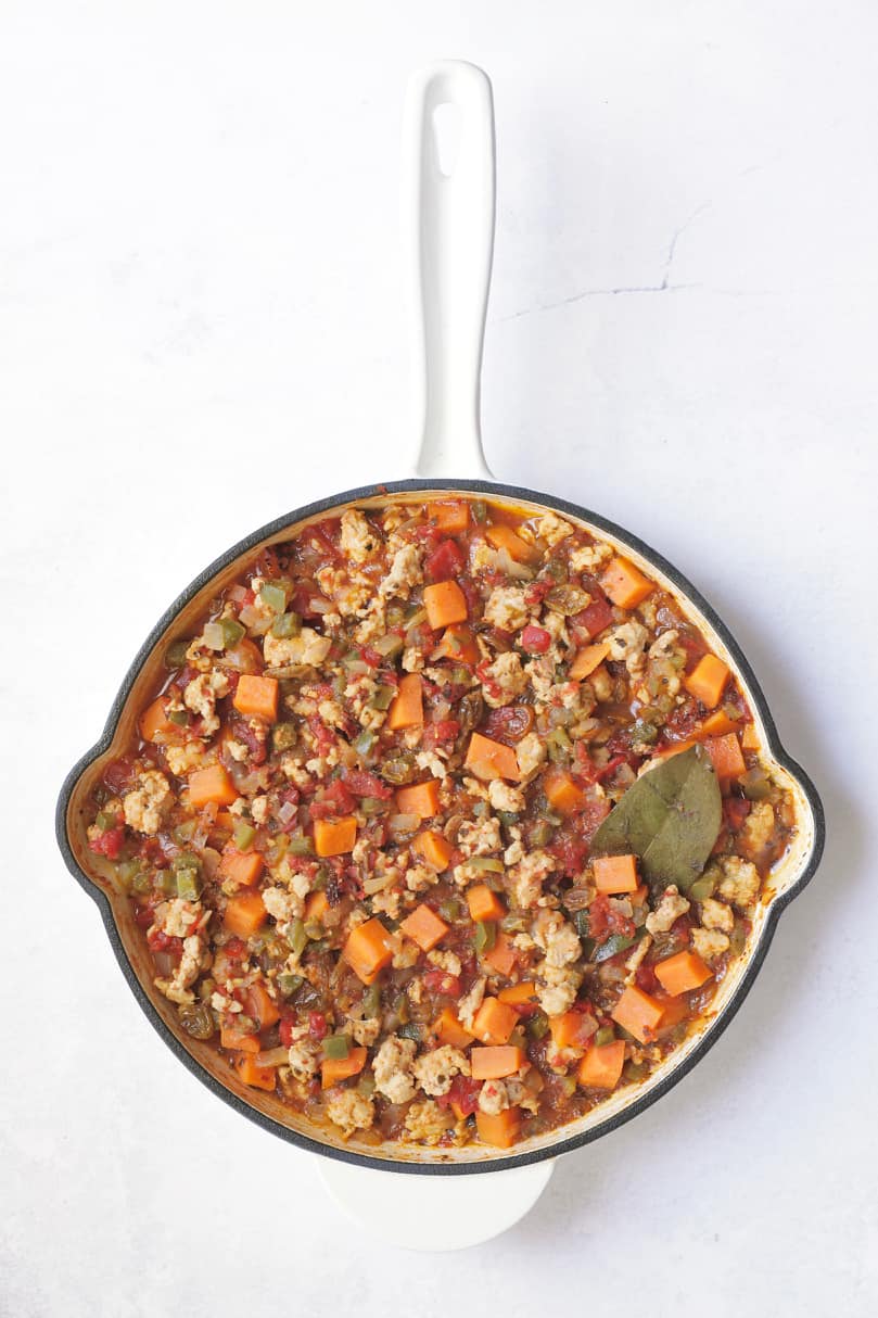 Remaining ingredients for picadillo combined and cooked.