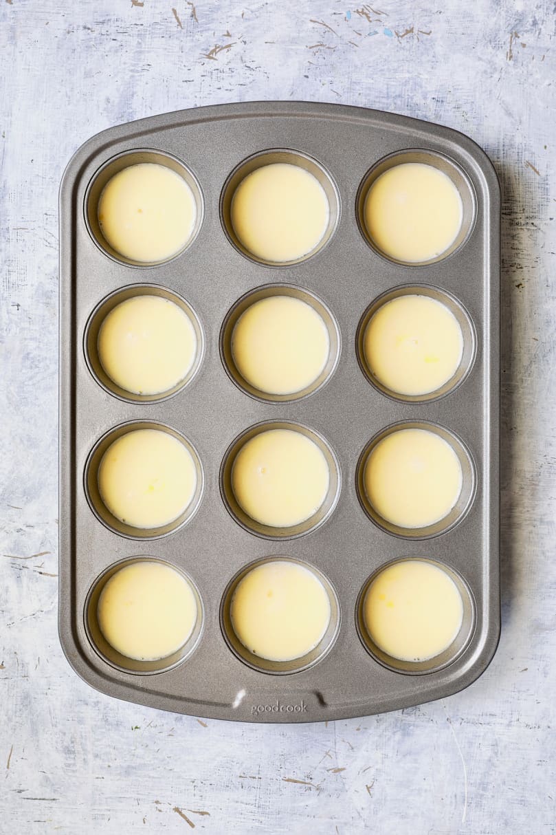 Photo of egg and milk combination in muffin pan.