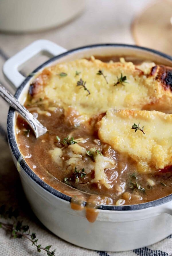 French Onion Soup for Two - Close-up shot with spoon lifting out some of the soup