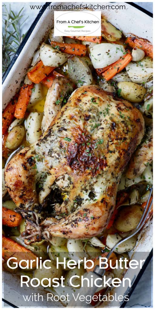 Garlic Herb Butter Roast Chicken with root vegetables in white roasting pan.