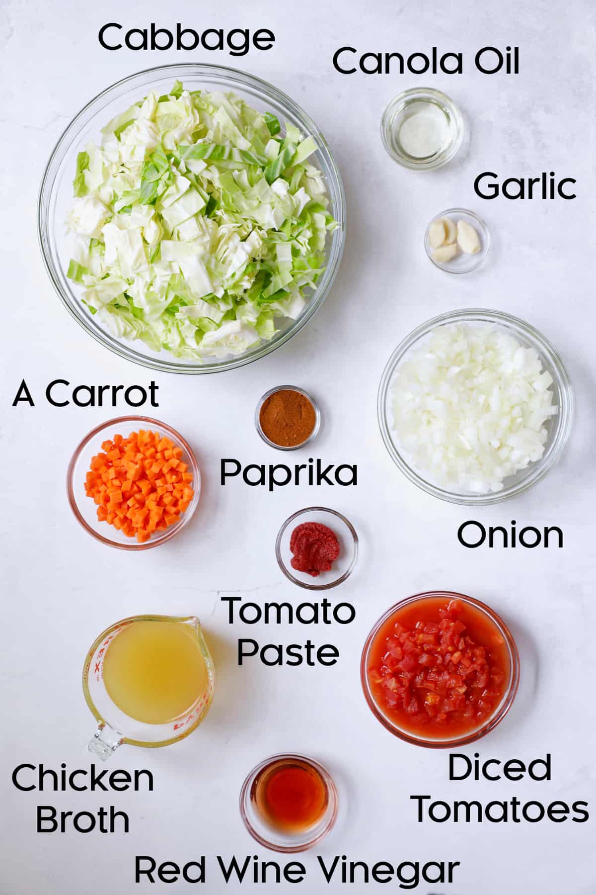 Photo of ingredients for Polish Stewed Cabbage (Kapusta) in glass bowls.