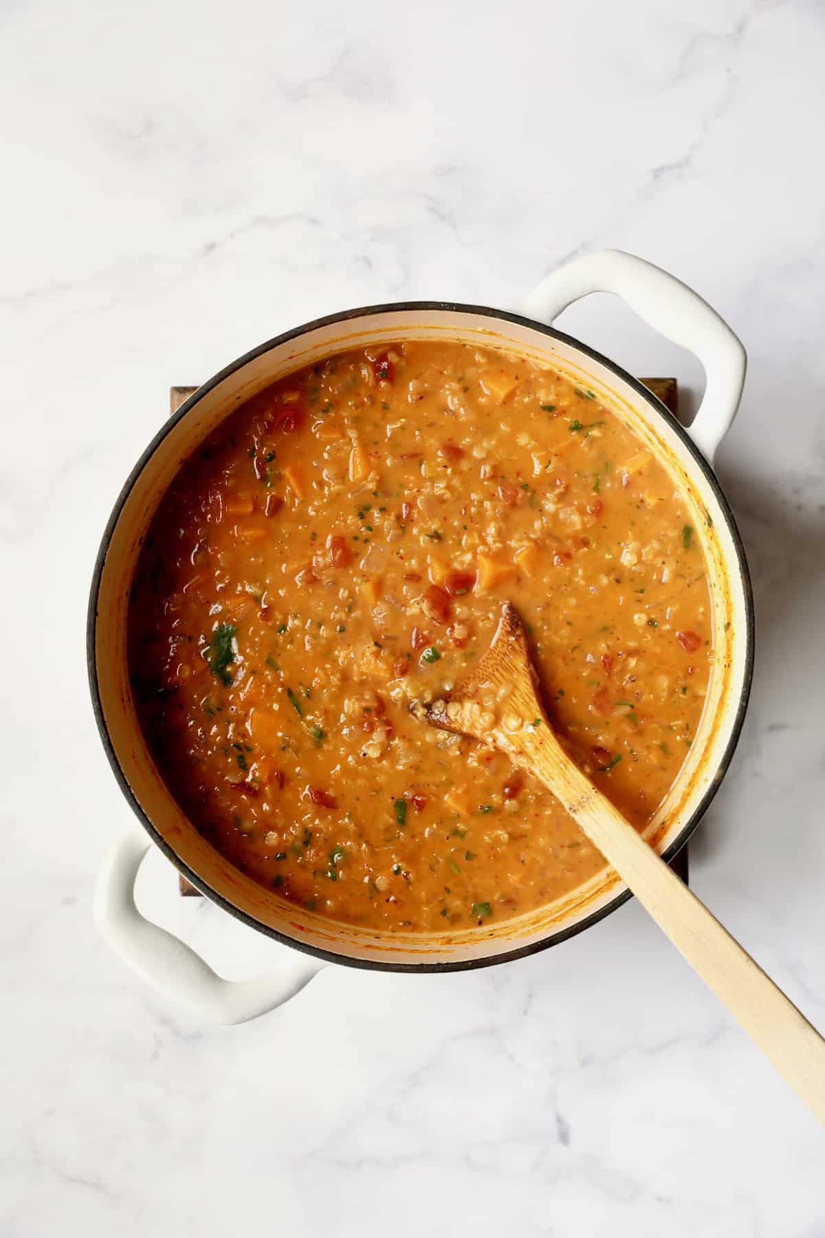 Process photo of Thai Red Curry Sweet Potato and Lentil Soup after coconut milk gets added.