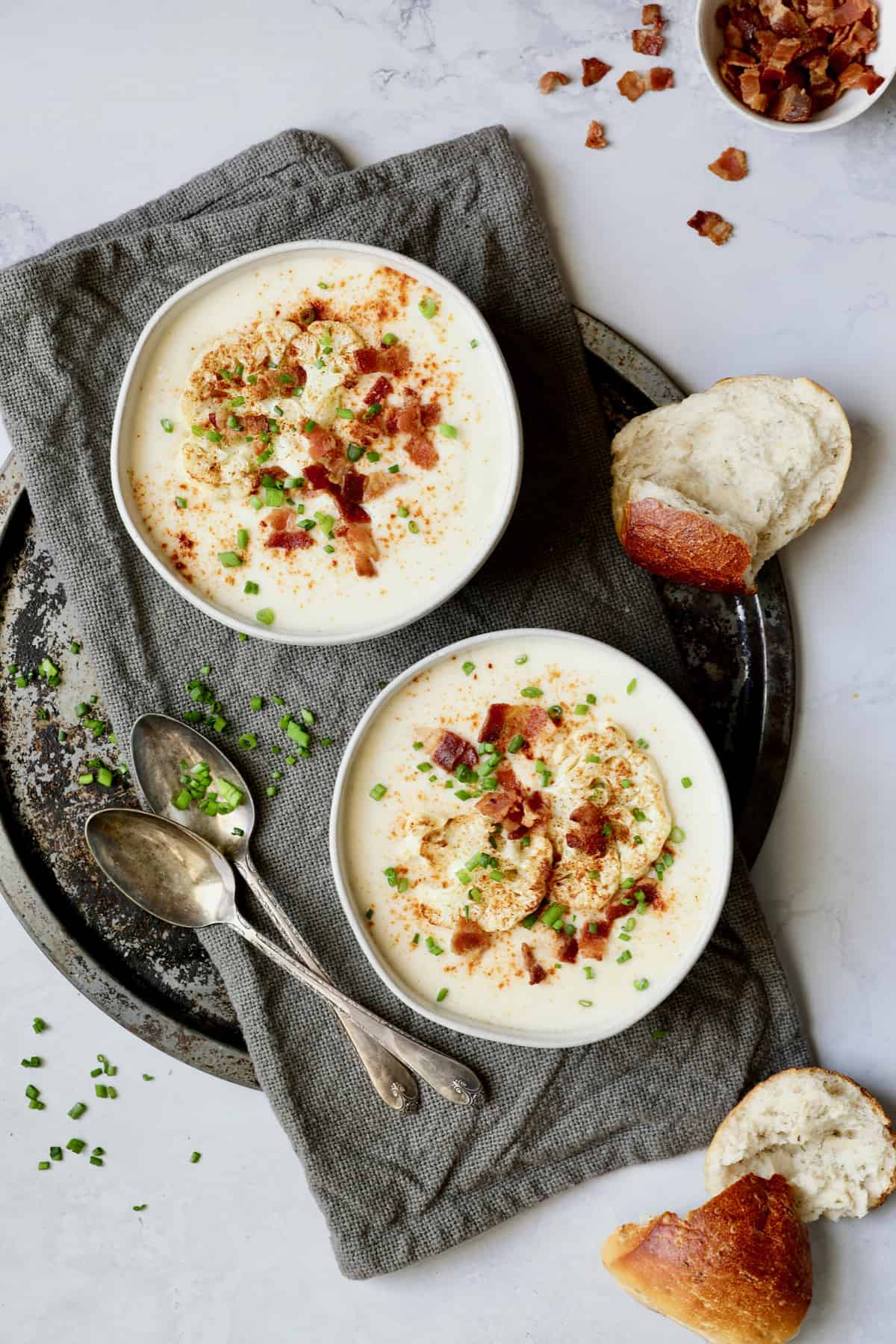 Cauliflower Potato Soup with Smoked Gouda garnished with roasted cauliflower, bacon and chives.