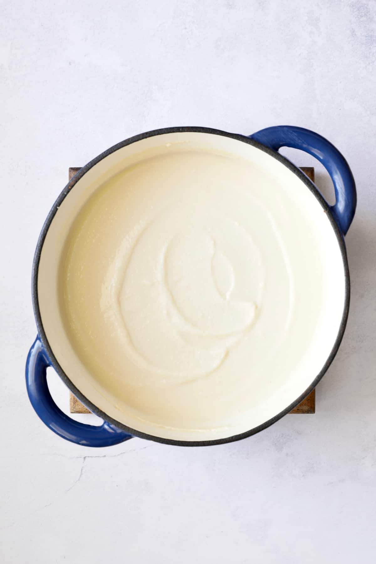 Cauliflower Potato Soup with Smoked Gouda in Dutch oven after being pureed.