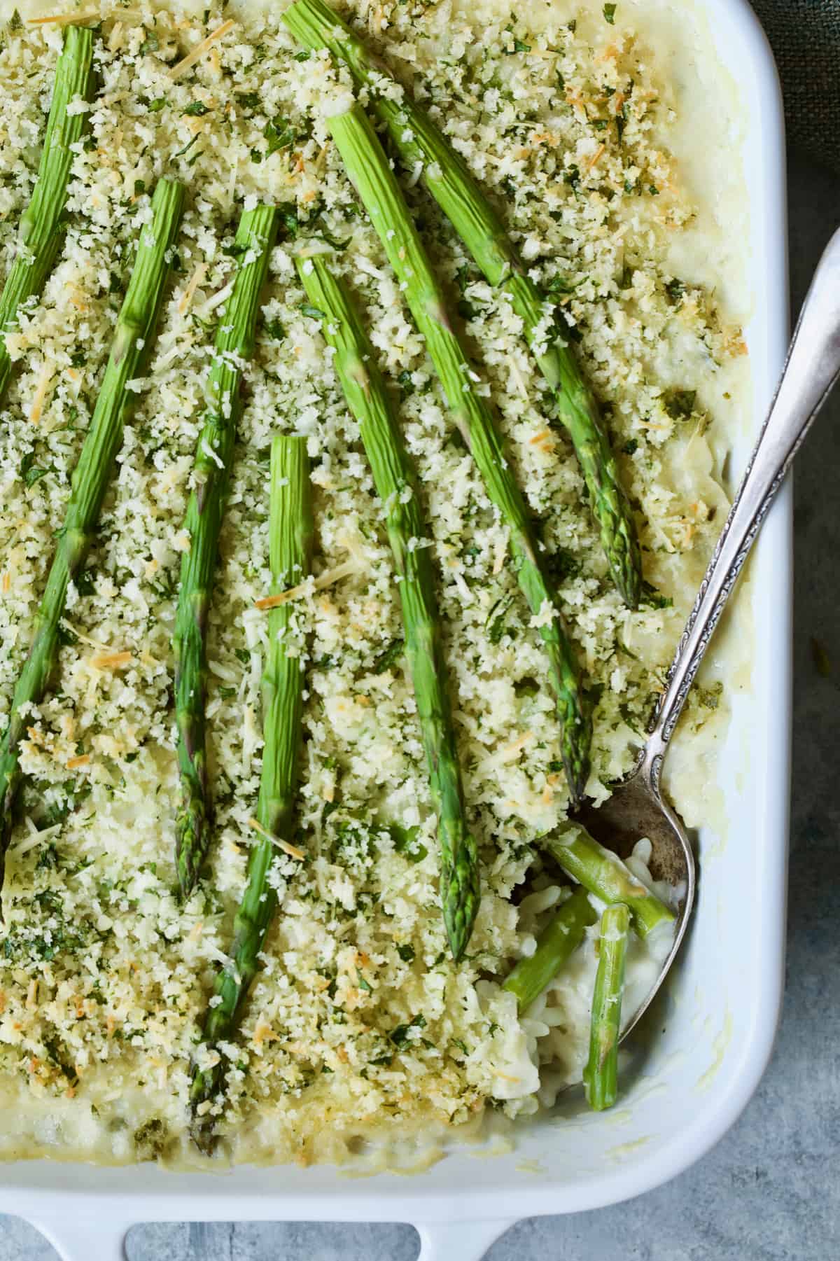 Photo of Creamy Asparagus and Rice Casserole with spoon serving some of the casserole.