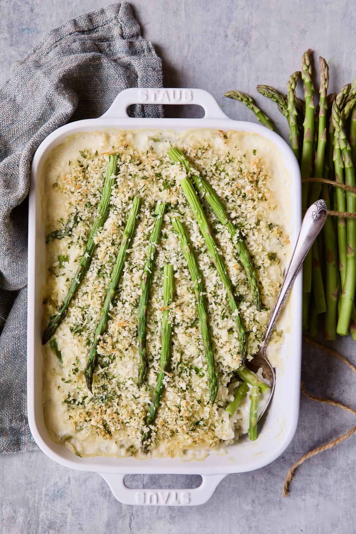 Photo of Creamy Asparagus and Rice Casserole with gray napkin.