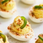 Close-up photo of Jalapeno Pimento Cheese Deviled Eggs garnished with jalapeno.