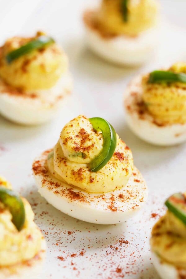Close-up photo of Jalapeno Pimento Cheese Deviled Eggs garnished with jalapeno.