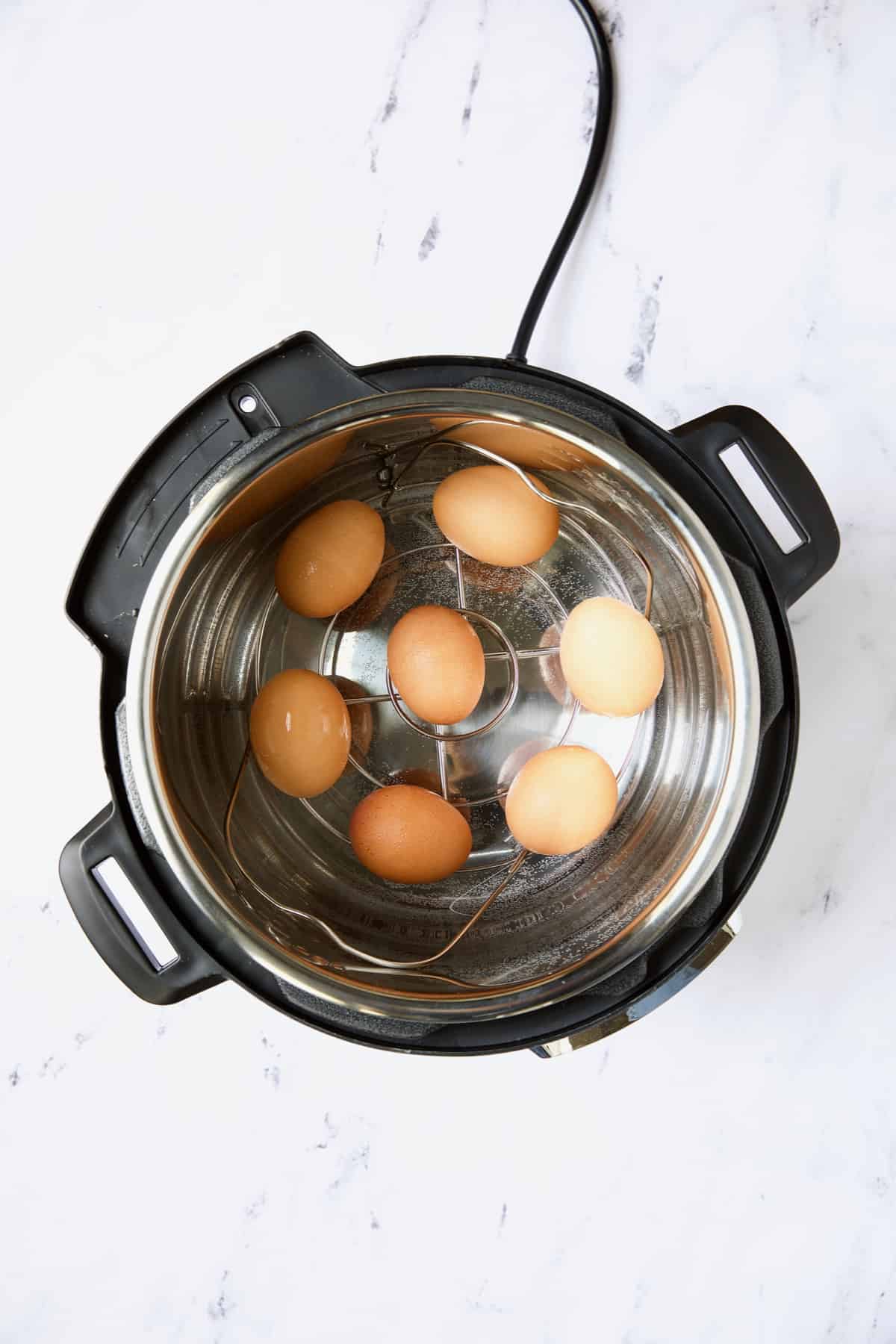 Photo of seven eggs in Instant Pot.