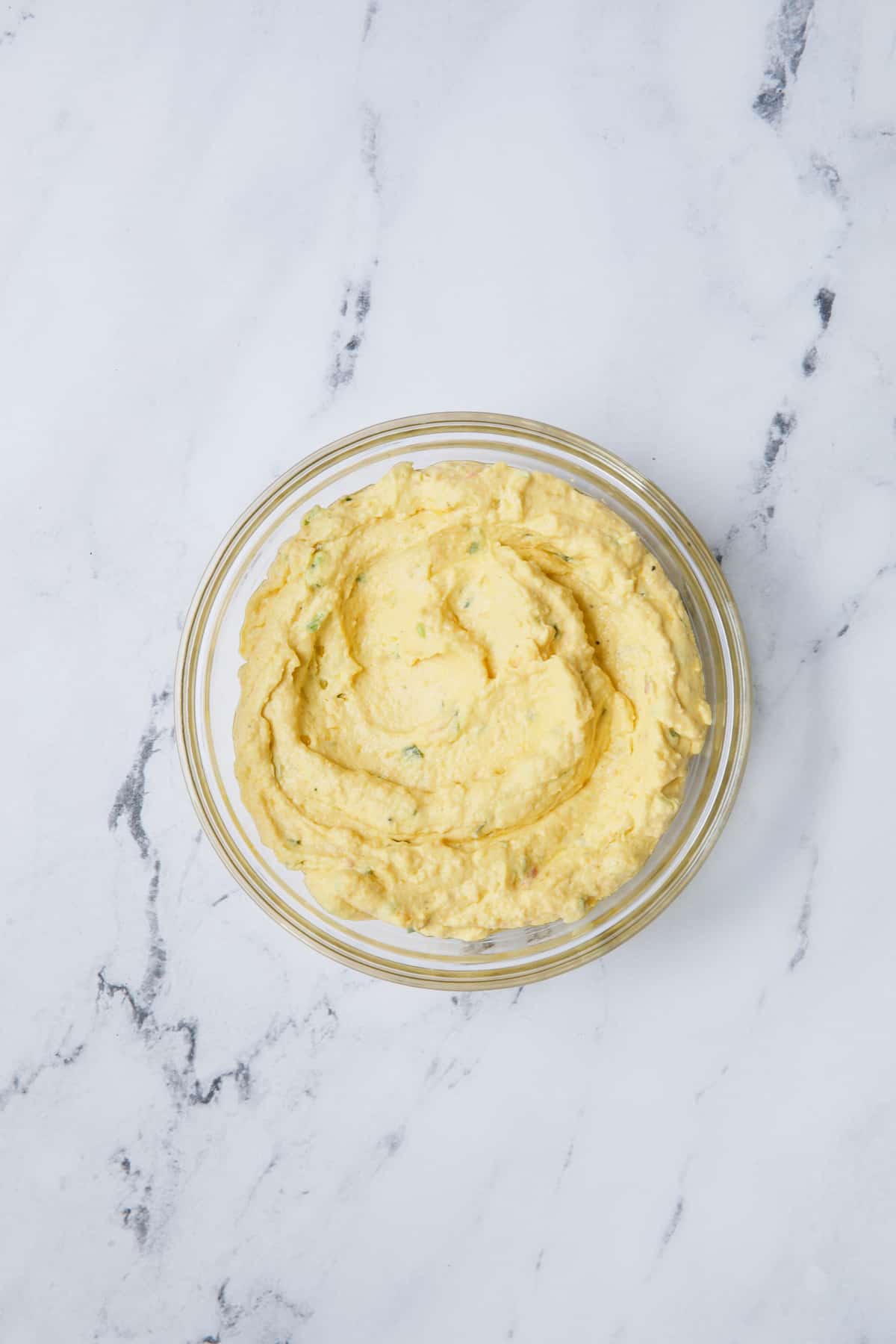Photo of filling for Jalapeno Pimento Cheese Deviled Eggs in glass mixing bowl.