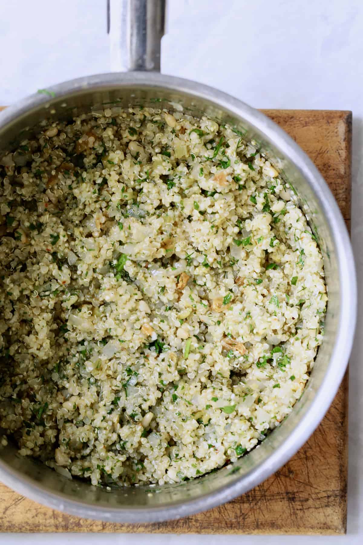 Photo of cooked quinoa in stainless steel saucepan.