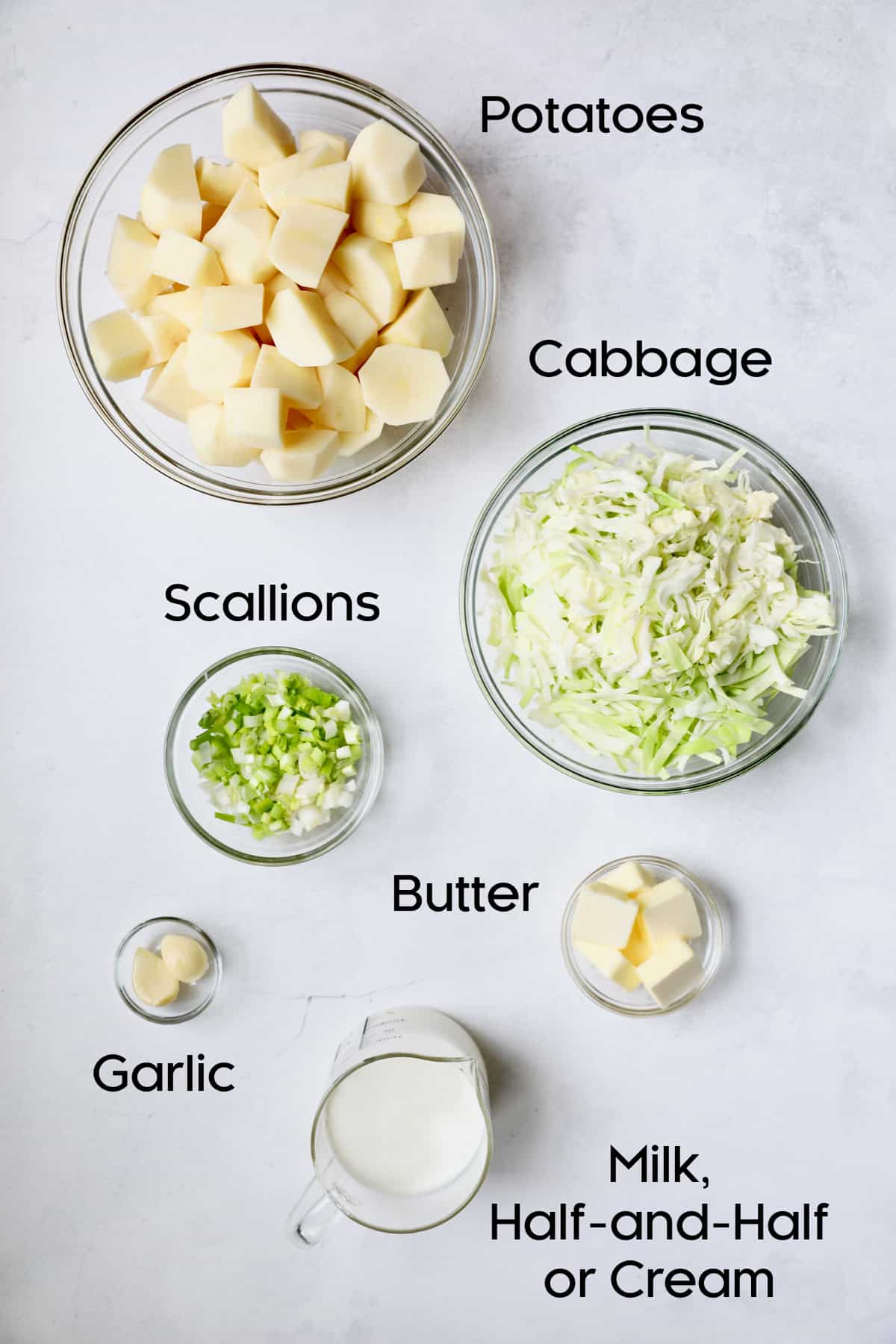 Photo of ingredients for colcannon in glass bowls.