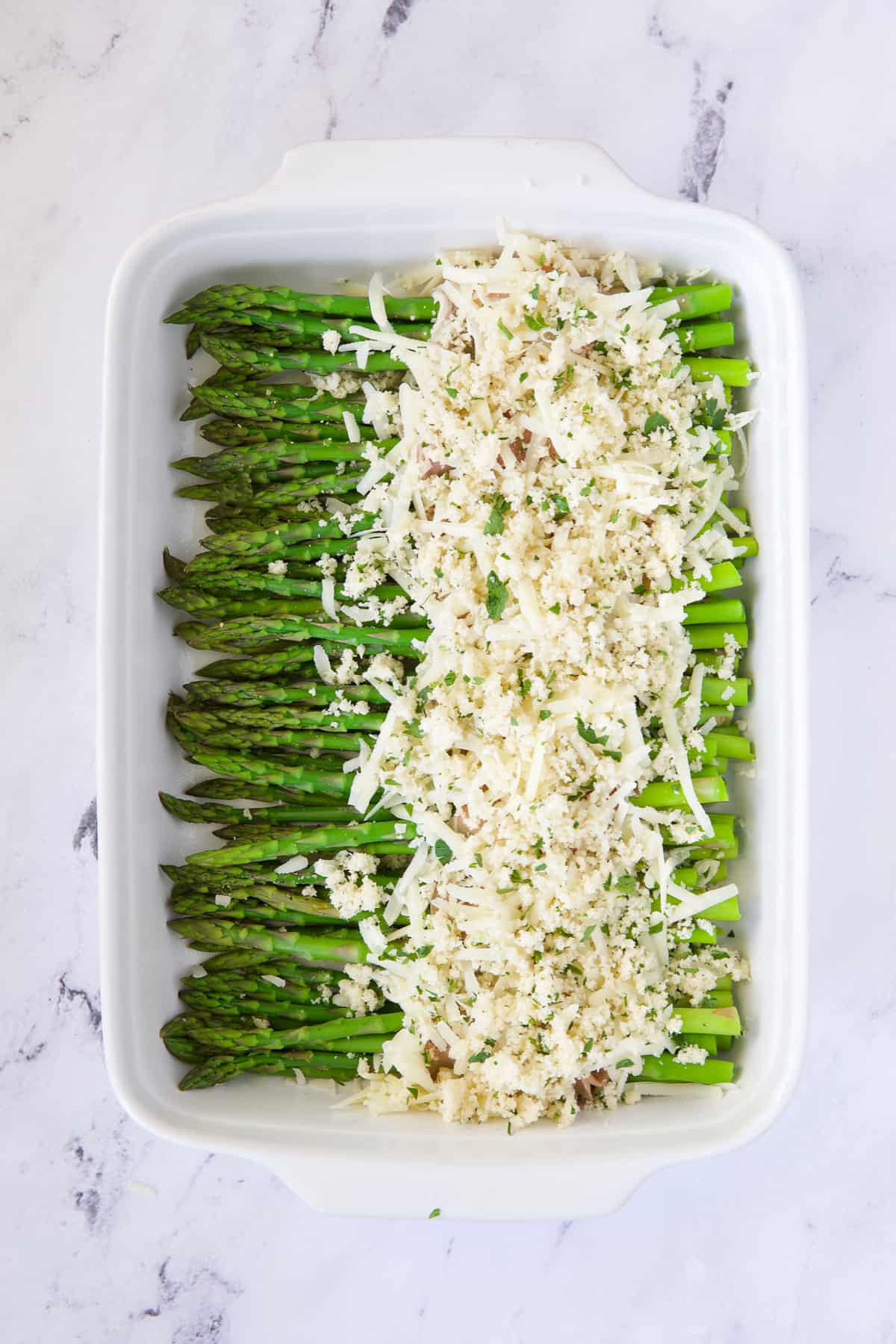 Photo of asparagus topped with cheese and breadcrumb topping.