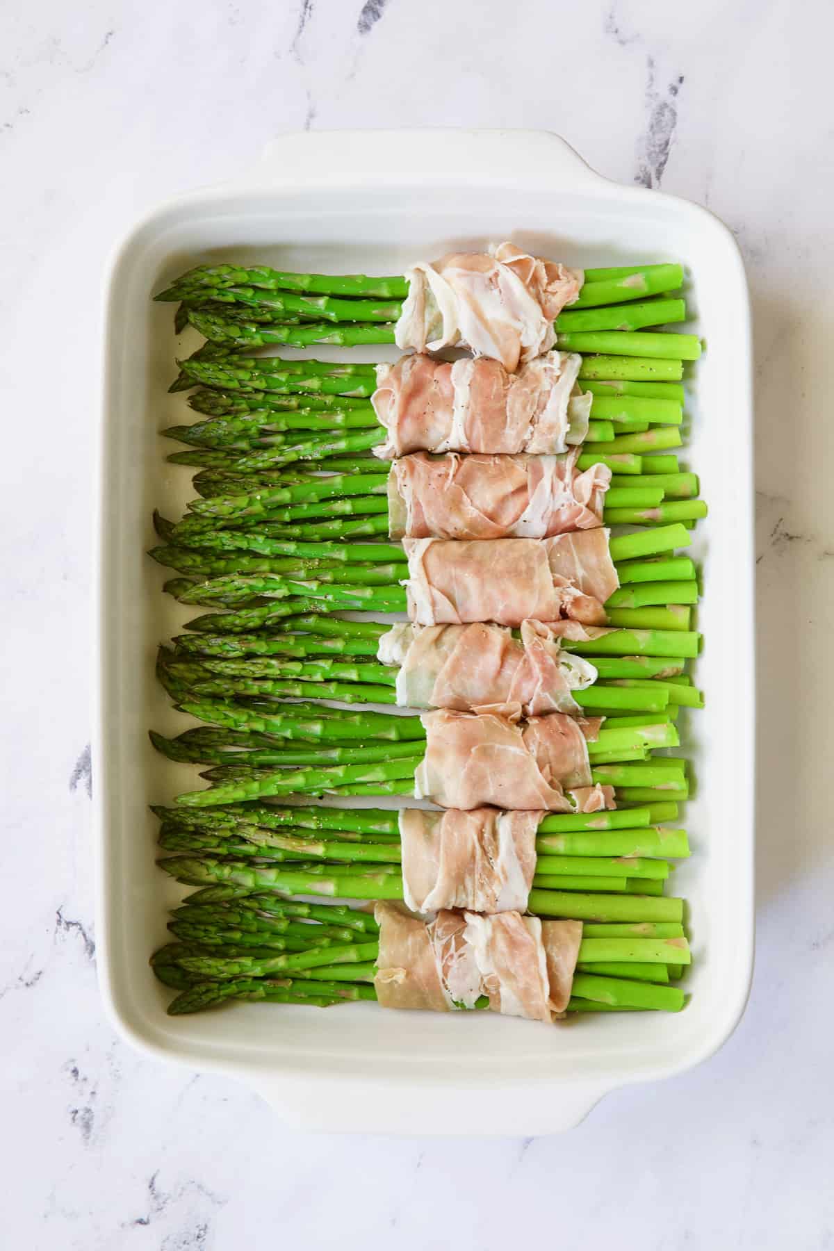 Photo of bundles of asparagus wrapped in prosciutto.